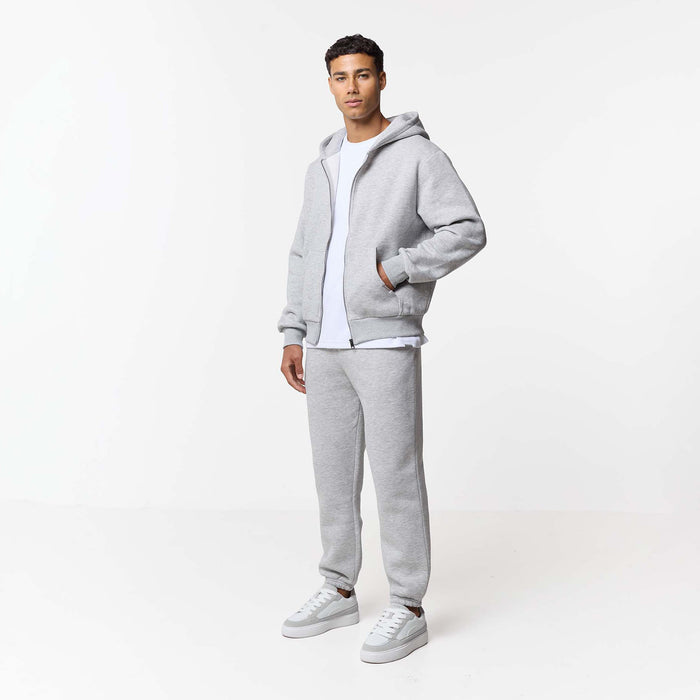 Relaxed fit zip up hoodie paired with white t-shirt and cuffed tracksuit bottoms