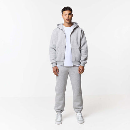 Front view of zip up grey hoodie and cuffed tracksuit bottoms in grey marl