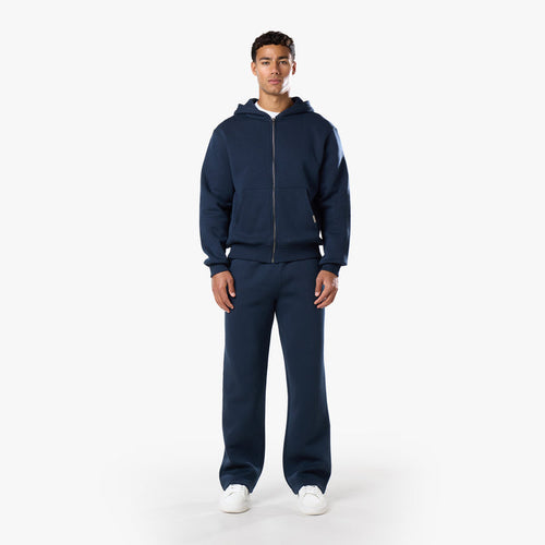 Front view of model in mens relaxed fit navy tracksuit