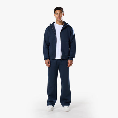 Front view of relaxed fit navy tracksuit with zip of hoodie undone