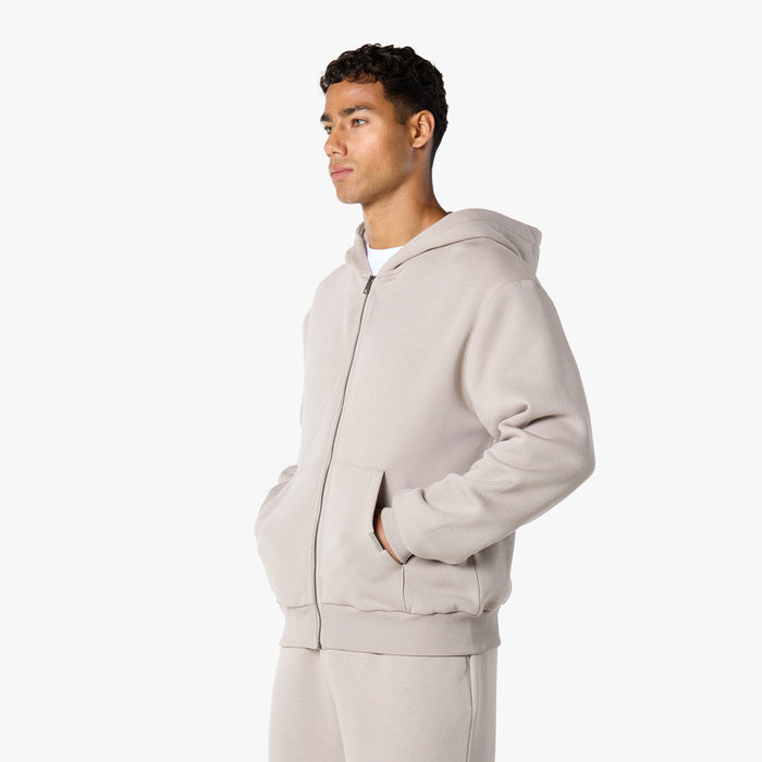 Model wearing relaxed fit hoodie in stone