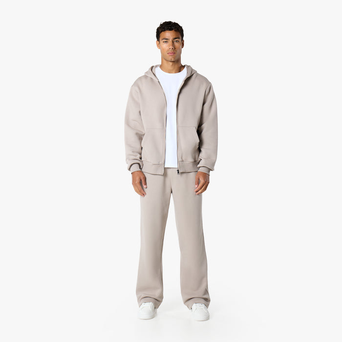 Front view of model in relaxed fit tracksuit in stone