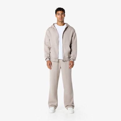 Front view of model in relaxed fit tracksuit in stone
