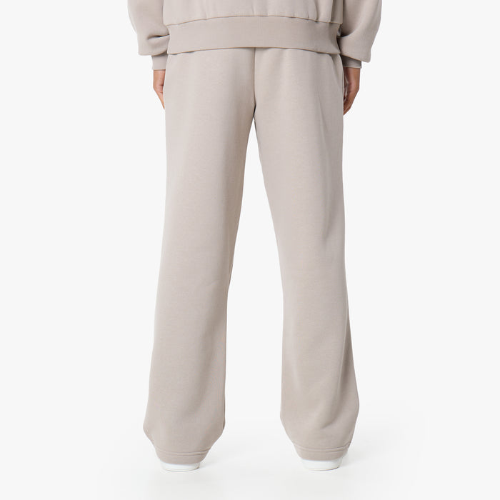 Rear view of men's loose fit tracksuit bottoms in stone