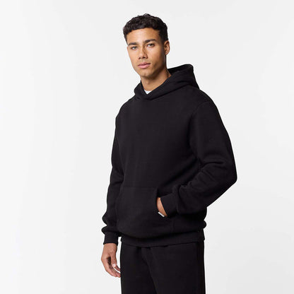 Mens black relaxed fit hoodie with models hand in pocket