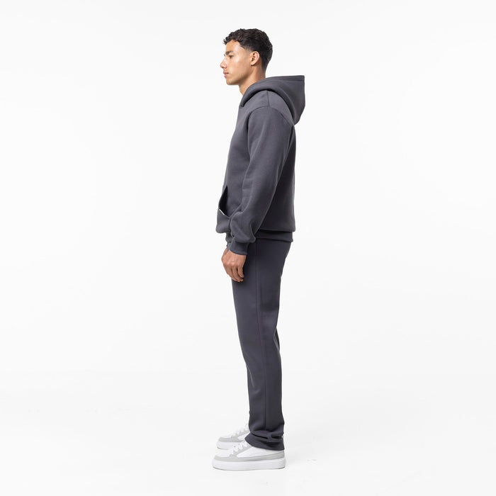 Full side view of relaxed fit tracksuit in dark grey