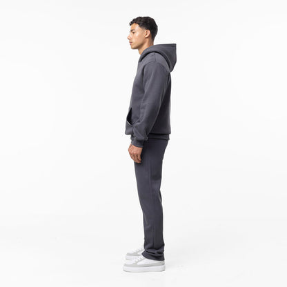 Full side view of relaxed fit tracksuit in dark grey
