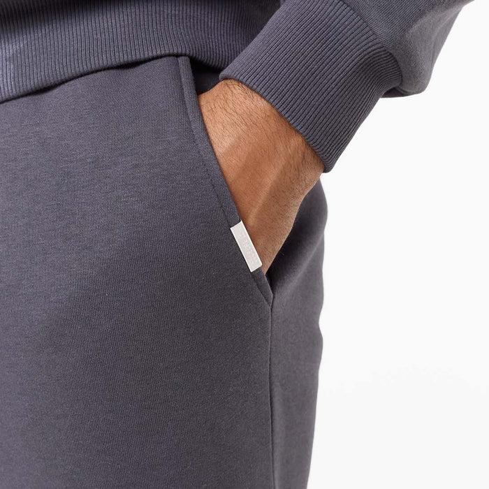 Close up of branded detailing on iron grey relaxed fit tracksuit bottoms