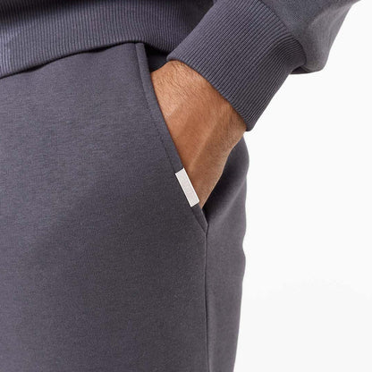 Close up of branded detailing on iron grey relaxed fit tracksuit bottoms