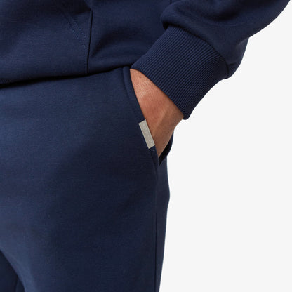 Branded detailing on pocket of cuffed navy tracksuit bottoms