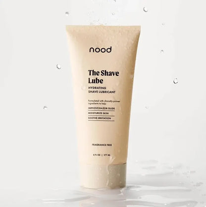 Nood The Shave Lube hydrating shave lubricant tube splashing in water on white background