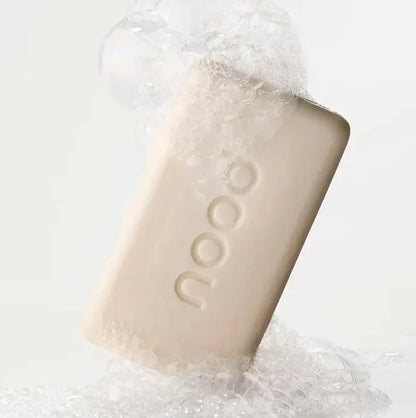 Nood Buff Bar soap bar with foam and bubbles on white background