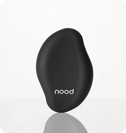 Nood The Eraser IPL hair removal device in black on a light grey background with reflection