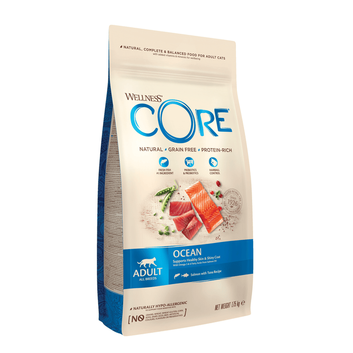 White background with a picture of a bag of Wellness CORE Sterilised Original Cat Food. On the bag is pictures of salmon fillet, tuna chunks, peas and cranberries. The text on the bag 'Wellness CORE, Natural, Grain Free, Protein-Rich' and 'Adult, All breeds, Ocean Salmon with Tuna Recipe'.