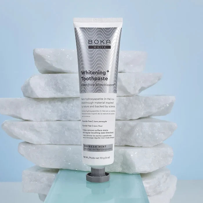 Boka Toothpaste tube on a stack of white stones with a light blue background